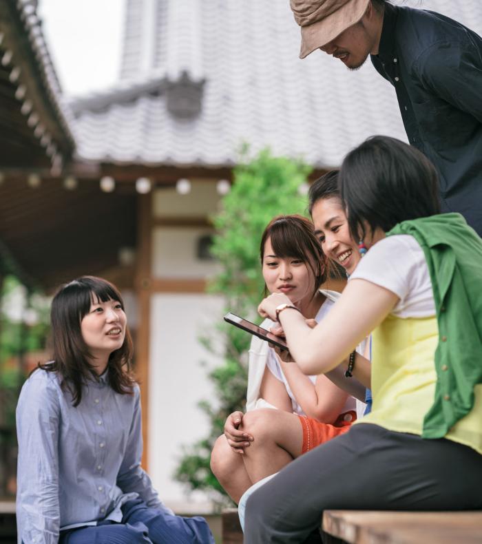 group-of-japanese-tourists-using-a-tablet-2024-09-15-11-25-43-utc